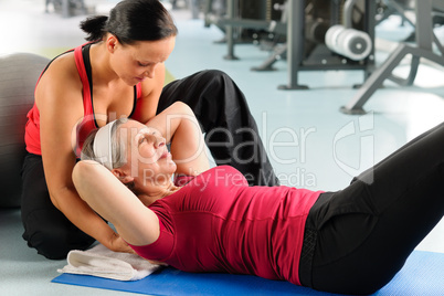 Senior woman exercise abdominal in fitness center