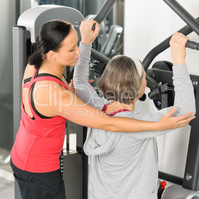 Fitness center trainer senior woman exercise back