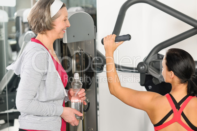 Personal trainer at fitness center showing exercise