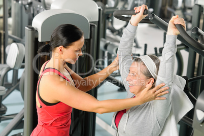 Senior woman exercise on shoulder press machine