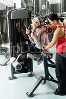 Fitness center senior woman exercise with trainer