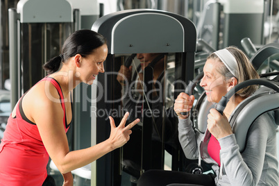 Personal fitness trainer with senior woman exercise
