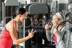 Personal fitness trainer with senior woman exercise