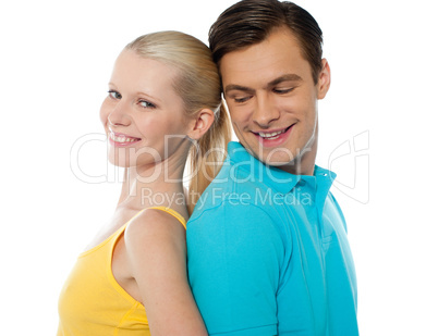 Closeup shot of a young couple, back to back