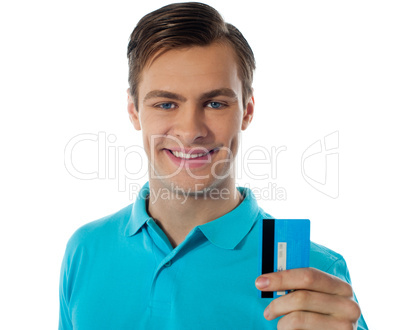Close-up portrait of fashionable guy holding debit card
