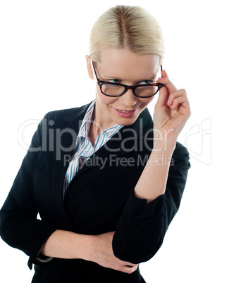 Corporate woman taking a closer look from within her glasses
