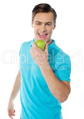 Handsome young caucasian biting an apple