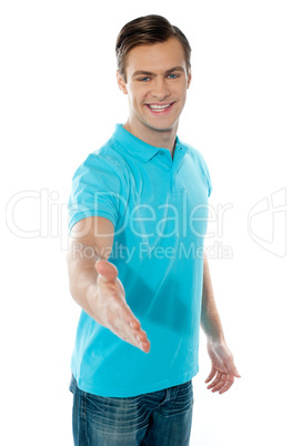 Charming young boy offering handshake