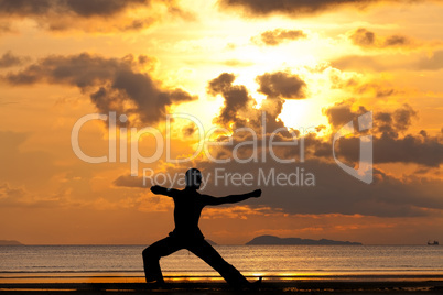Man silhouette doing yoga exercise archer