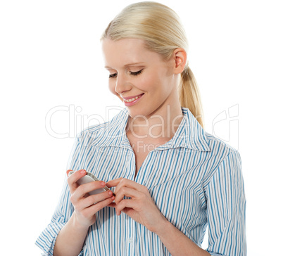 Smiling young corporate girl texting