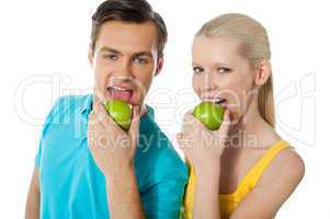 Healthy couple eating fresh green apple