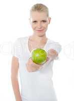 Cute teenager offering green apple
