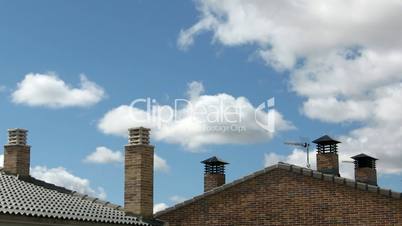 Smoke stacks and sky clouds