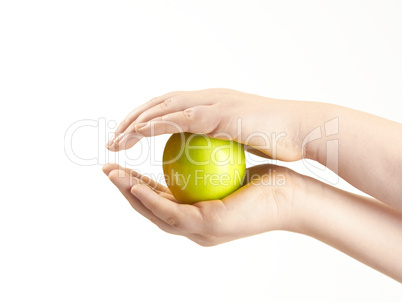 Apple sandwiched between childs hands