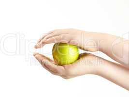 Apple sandwiched between childs hands