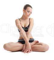 Beautiful young woman sit in lotos yoga pose