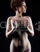 nude girl in dark hide breast with hands