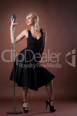 woman pin-up portrait in black with microphone