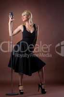 woman pin-up portrait in black with microphone