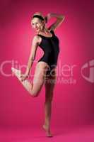 Young sport woman dance in pin-up style black suit