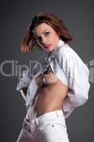 Beautiful naked brunette in white jeans and shirt
