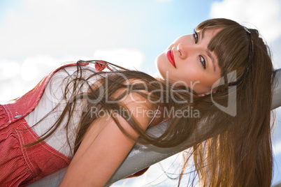 A beautiful girl with long hair coquettishly smiling