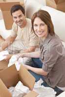 Happy Couple Unpacking or Packing Boxes Moving House