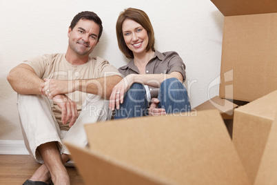 Happy Couple Unpacking or Packing Boxes Moving House