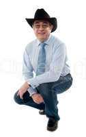 Image of a senior cowboy posing semi seated