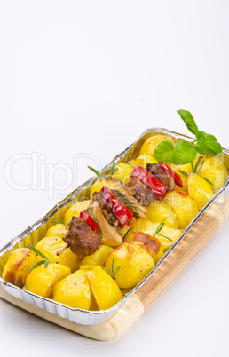 Meat spit with fried potatoes