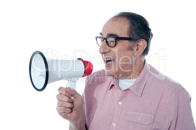 Elder casual man shouting through megaphone