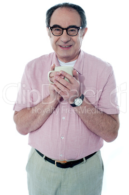 Old man holding a coffee mug