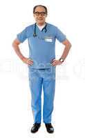 Full length view of smiling experienced medical professional