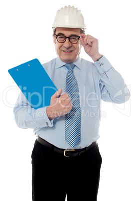 Smiling matured architect holding his eye-wear