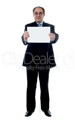 Senior business professional holding blank billboard