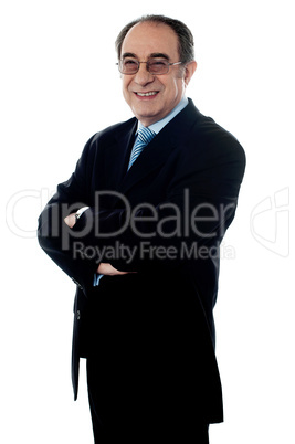 Welldressed company director posing with folded arms