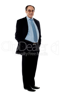 Full pose of a smiling senior company director
