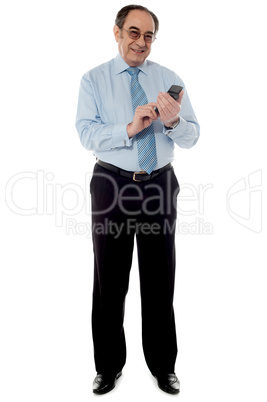 Handsome old corporate man using cellphone