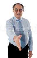 Confident modern businessman offering handshake