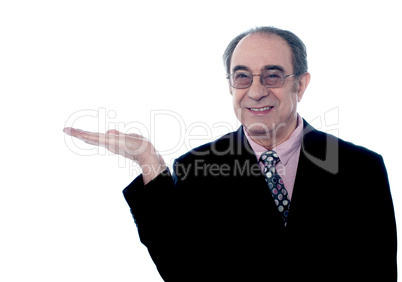 Senior executive posing with an open palm