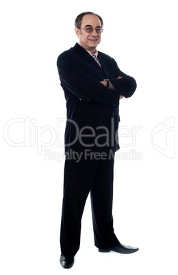 Handsome old manager standing with arms crossed