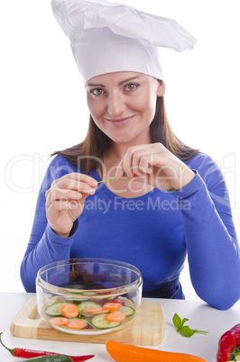 Woman with paprika and cucumber