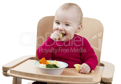 young child eating in high chair