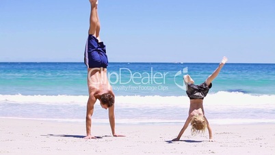 Mann und Kind machen einen Handstand