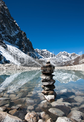 Harmony: Stone stack and Sacred Lake near Gokyo