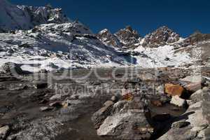Renjo pass: stream and peaks in Himalayas