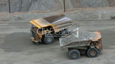 Mining dump trucks passing industry