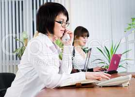 Young business ladies working in office