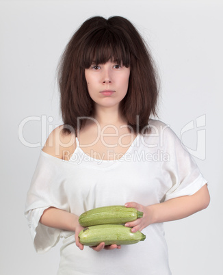 The young beautiful woman with the fresh vegetables