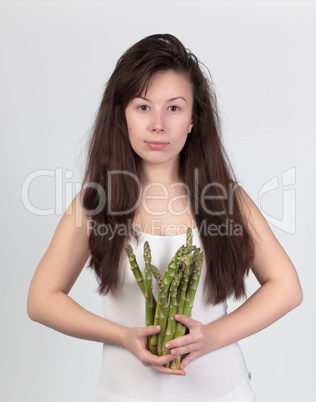 The young beautiful woman with the fresh vegetables